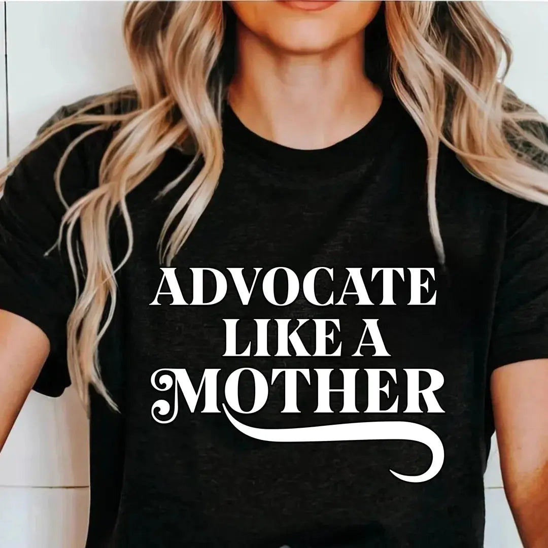 Woman wearing the black Advocate Like a Mother t-shirt, close view of the front print